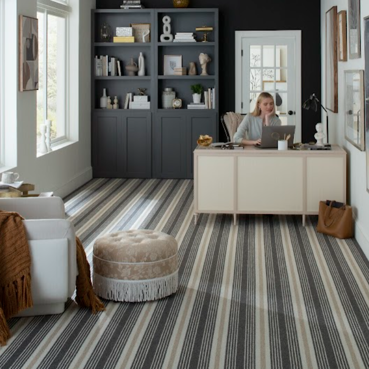 Karastan carpet promotion featuring striped patterned luxury carpet in a home office