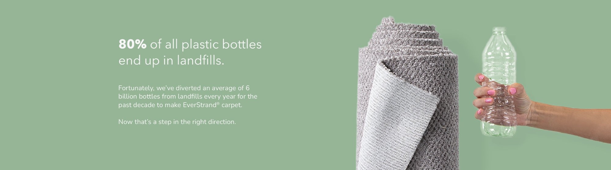Plastic bottle next to a rolled up rug on a green background